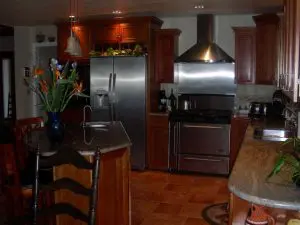 Modern kitchen design with granite counters and wood cabinets
