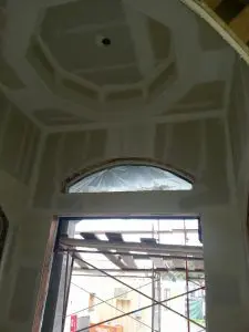 Interior drywall installation process at a new construction site