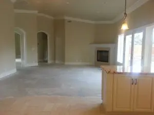 Open-concept living room and kitchen area in an unfurnished home