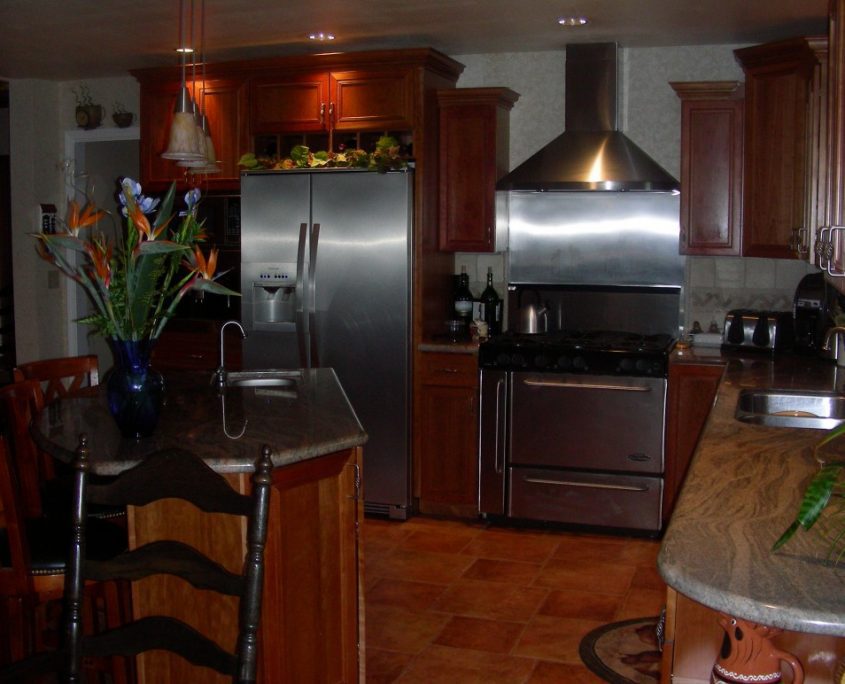 Modern kitchen design with granite counters and wood cabinets