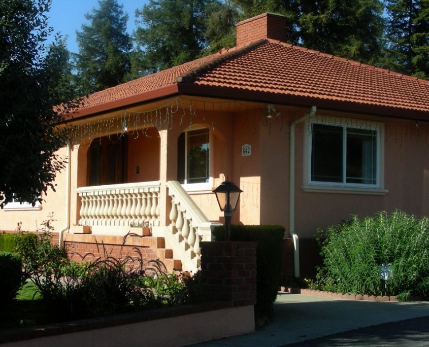 Mediterranean-style residential house under construction with red tiled roof and lightcolored exterior walls